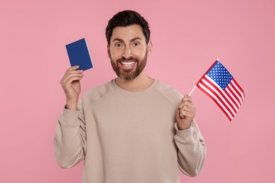 Photo of Immigration. Happy man with passport and American flag on pink background