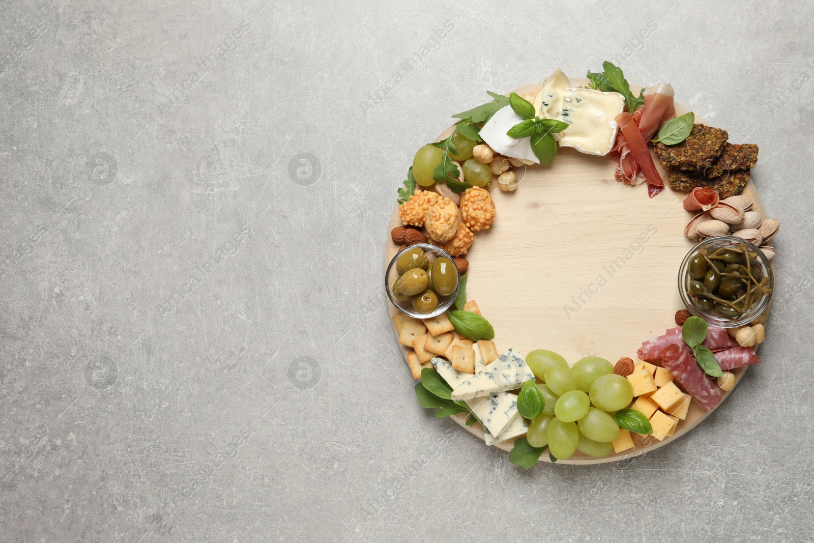 Photo of Different tasty appetizers on light table, top view. Space for text