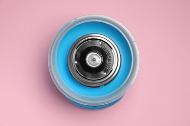 Photo of Portable candy cotton machine on pink background, top view