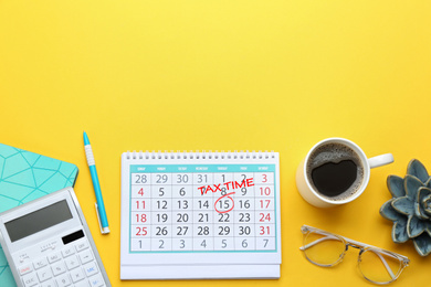 Image of Calendar with words TAX TIME and cup of coffee on yellow background, flat lay. Space for text