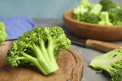 Photo of Fresh green broccoli on grey table, closeup. Organic food