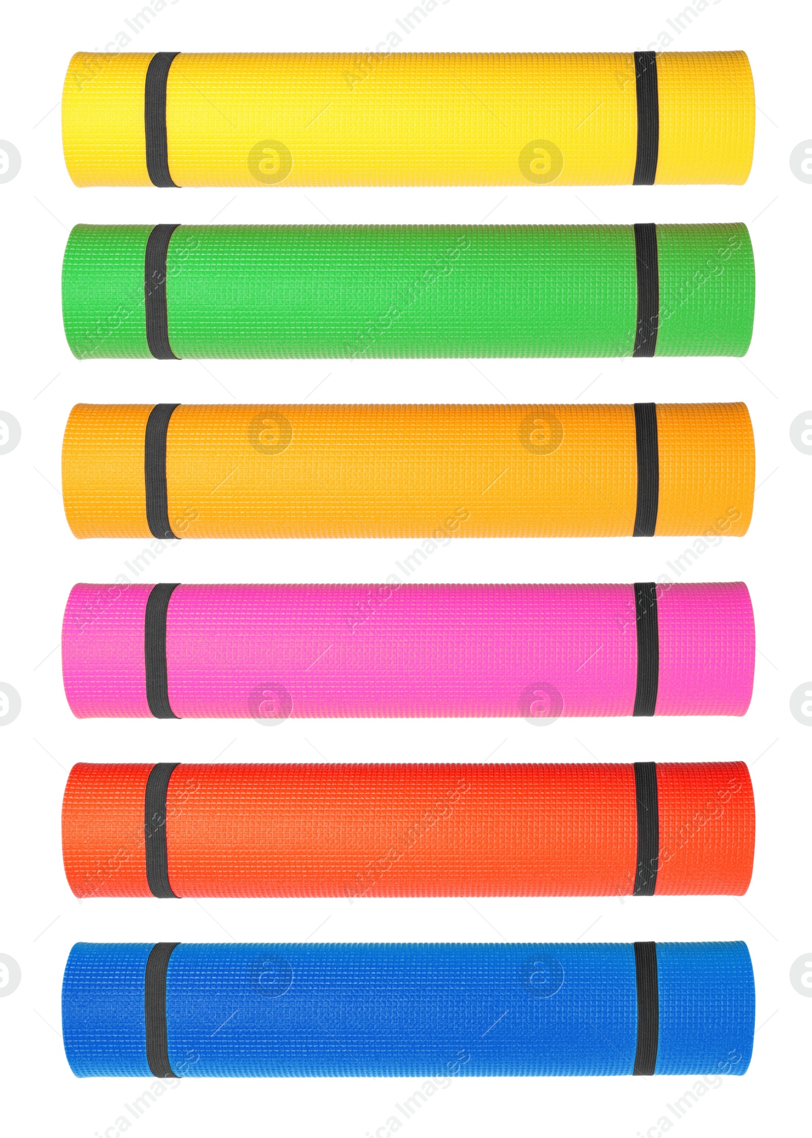 Image of Set with different bright rolled camping mats on white background. Vertical banner design  