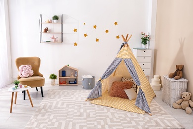 Cozy kids room interior with play tent and toys