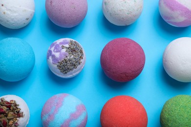 Photo of Colorful bath bombs on light blue background, flat lay