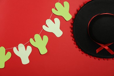 Black Flamenco hat and garland on red background