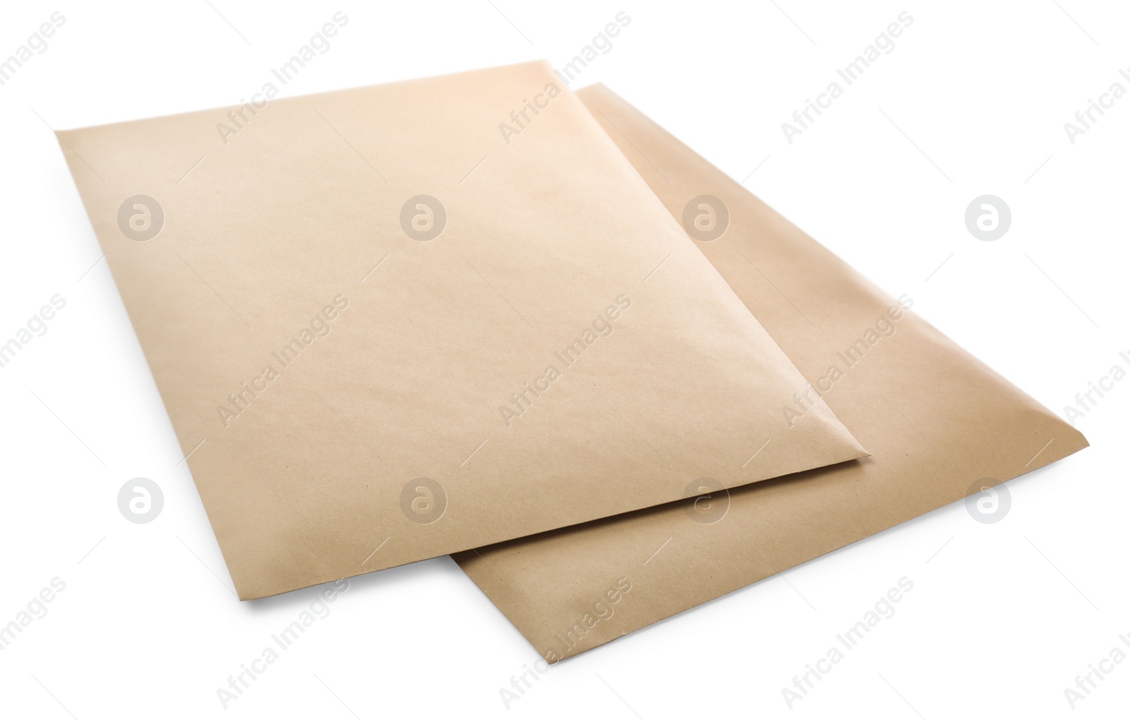Photo of Blank kraft paper envelopes on white background