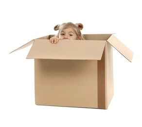 Cute little girl playing with cardboard box on white background