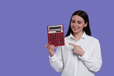 Smiling accountant with calculator on purple background, space for text