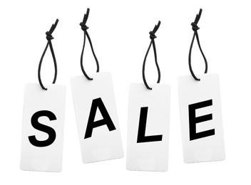 Cardboard tags with word SALE on white background