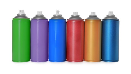 Photo of Cans of different spray paints on white background. Graffiti supplies