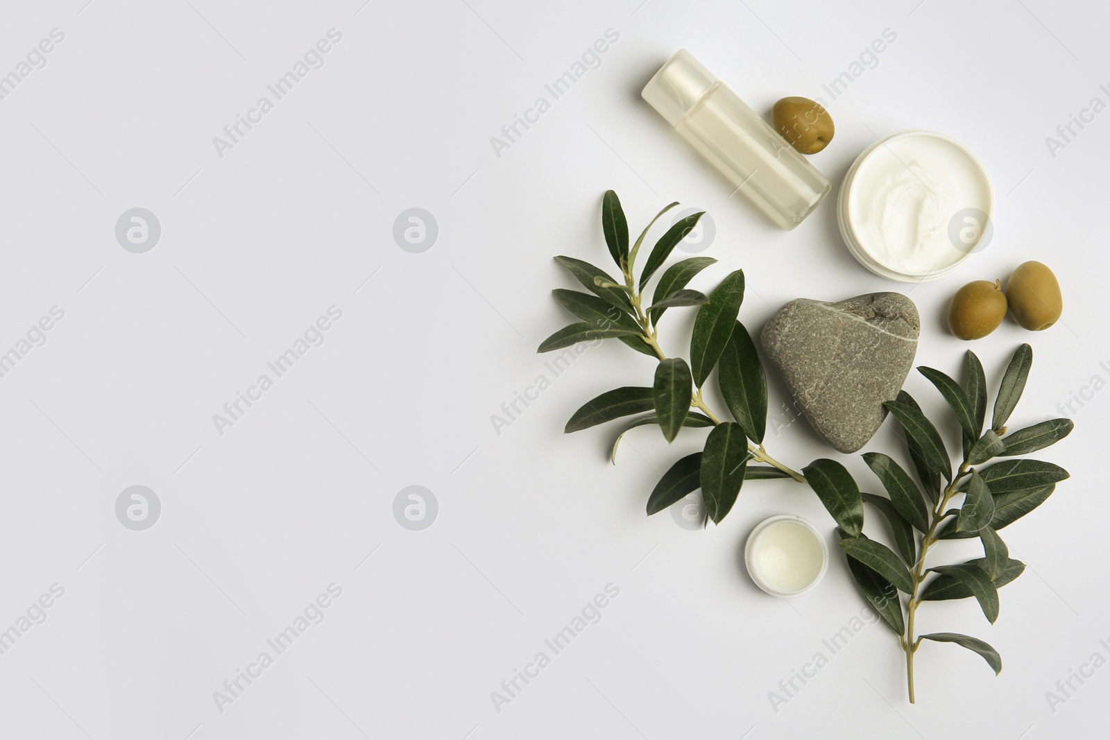 Photo of Flat lay composition with different cosmetic products and olives on white background. Space for text