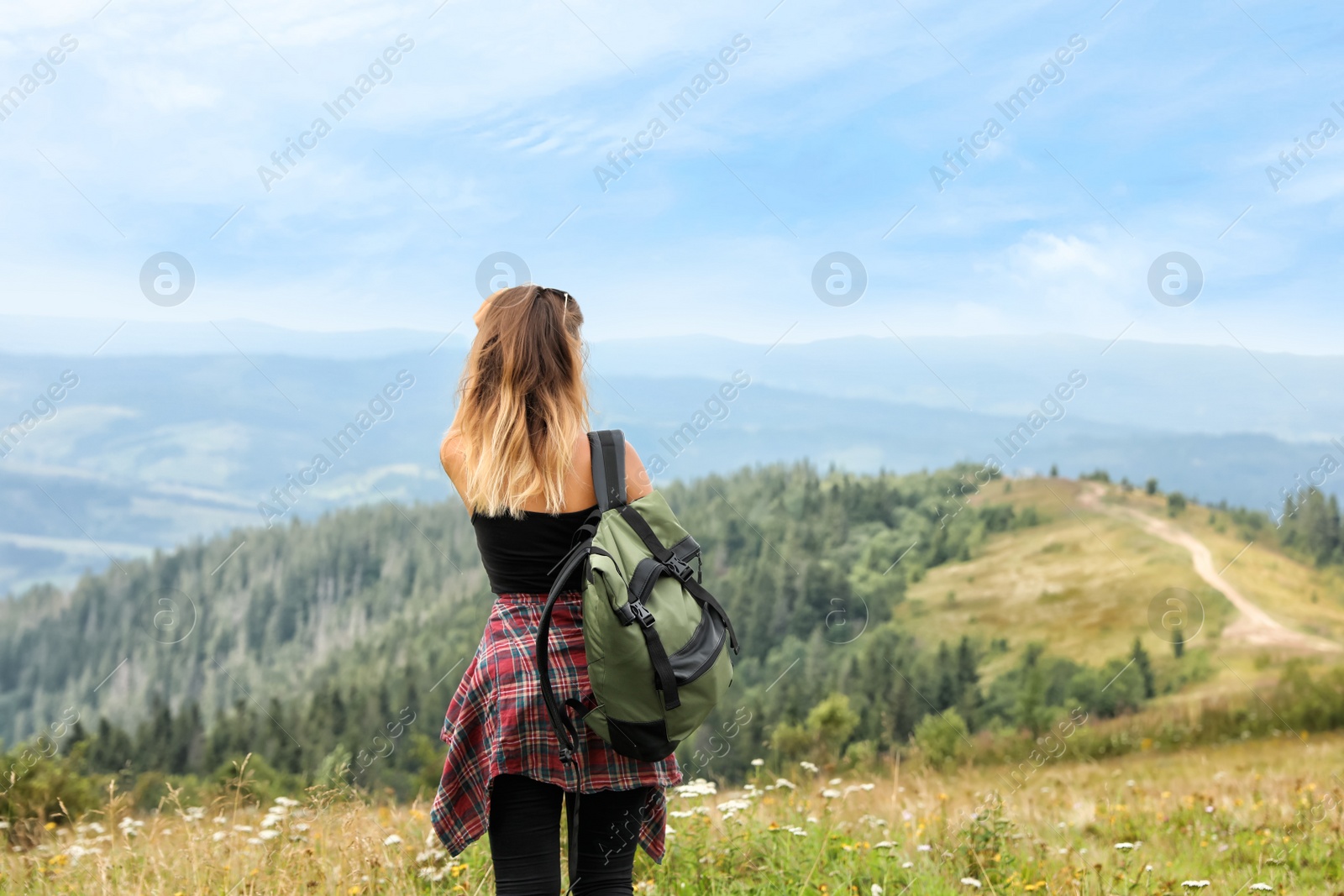 Photo of Woman with backpack in wilderness on cloudy day