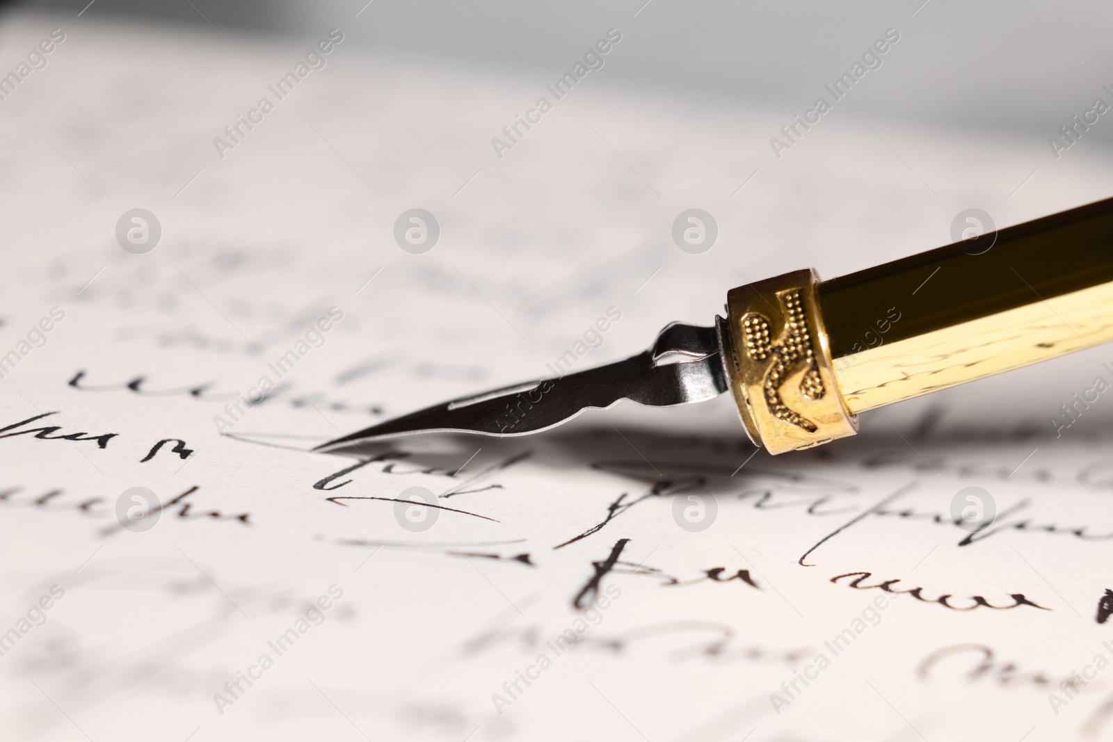 Photo of Writing letter with elegant fountain pen, closeup