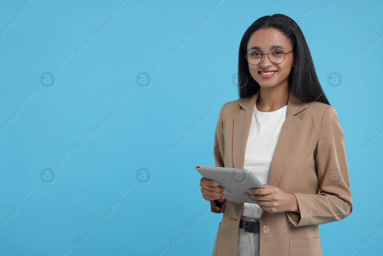 Photo of Beautiful secretary with tablet on light blue background, space for text