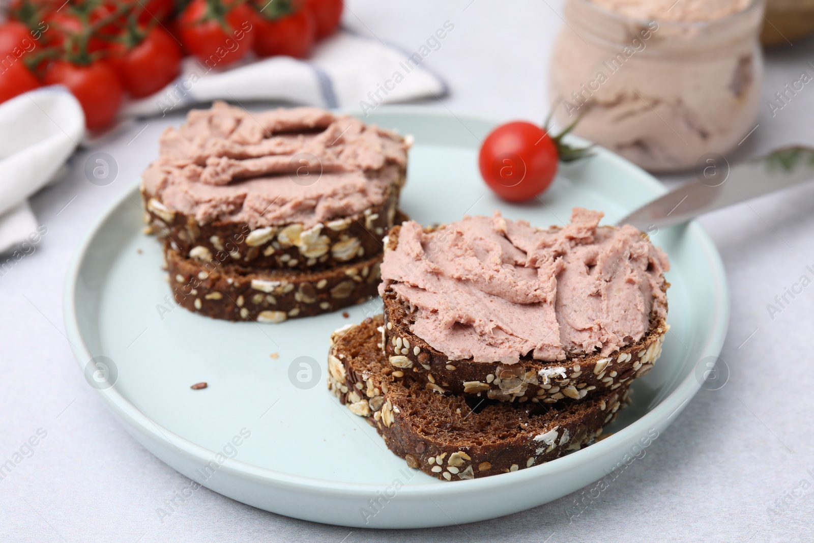 Photo of Delicious liverwurst sandwiches served on white table, closeup