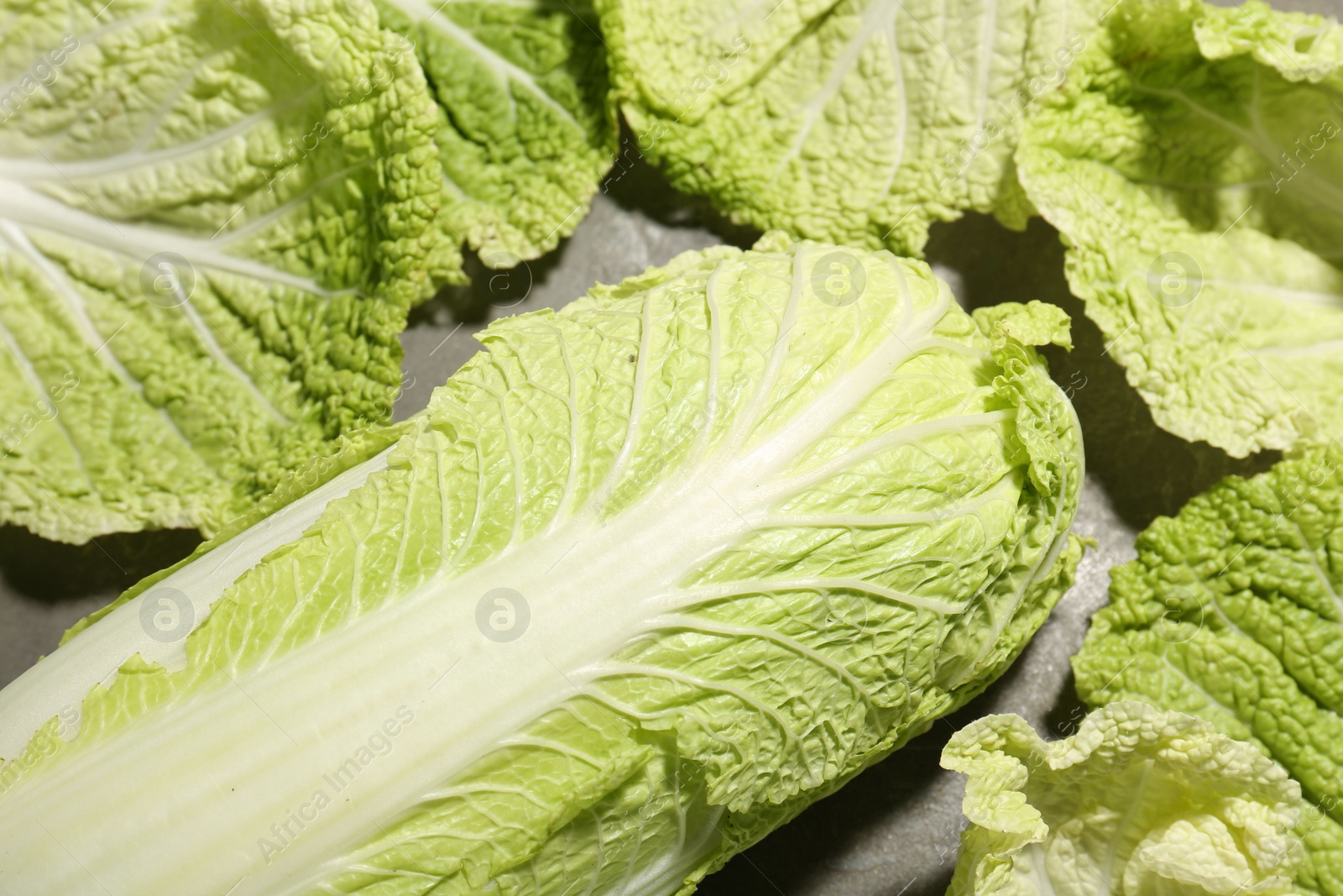 Photo of Fresh ripe Chinese cabbages on table, closeup