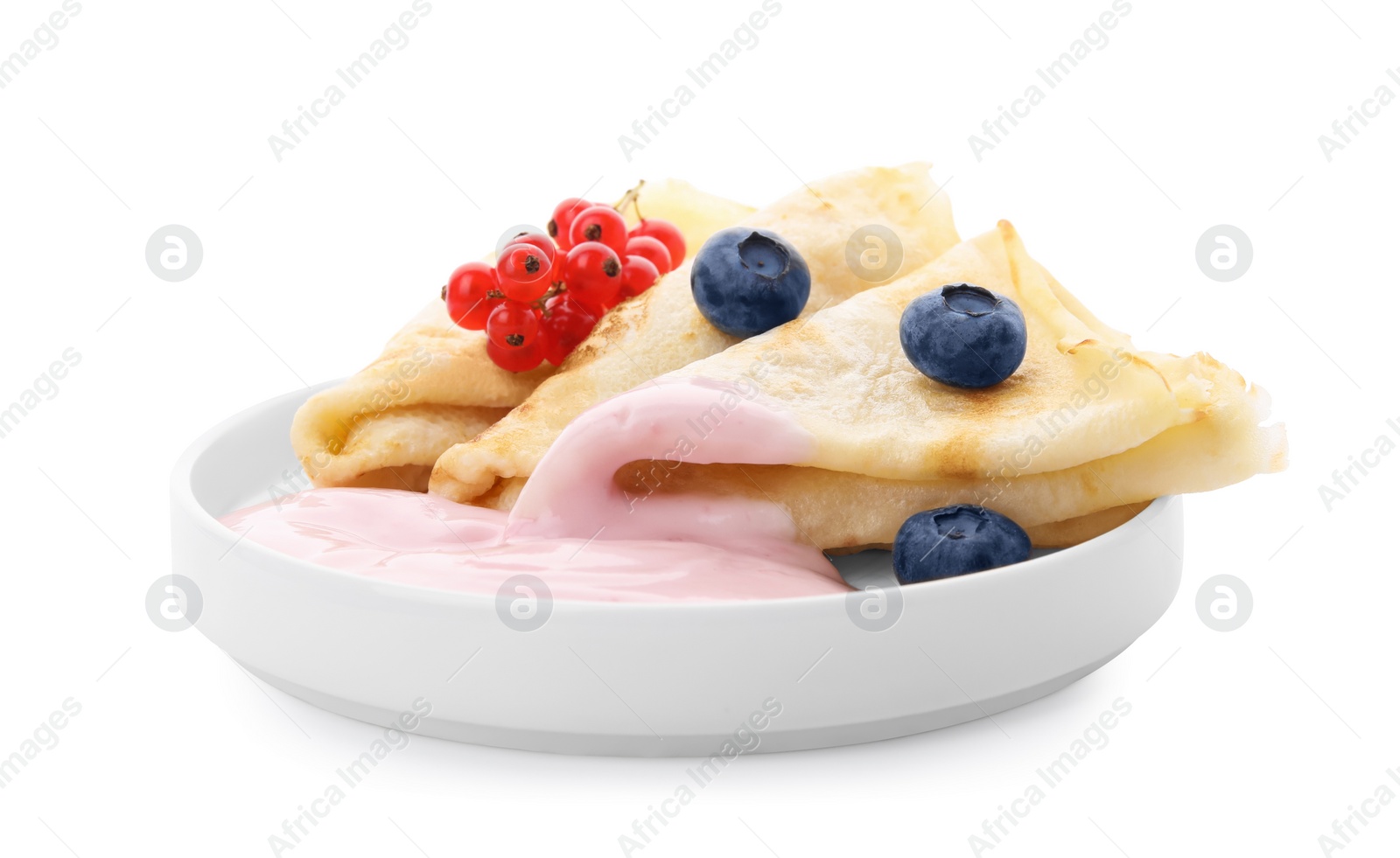 Photo of Delicious crepes with natural yogurt, blueberries and red currants on white background