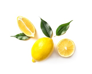 Flat lay composition with lemons and green leaves on white background