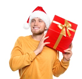 Young man with Christmas gift on white background