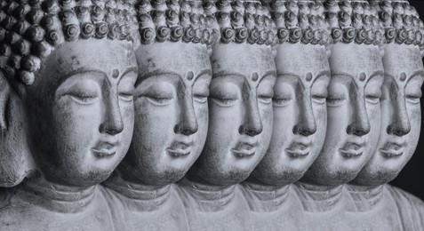Row of stone Buddha sculptures, banner design. World religion