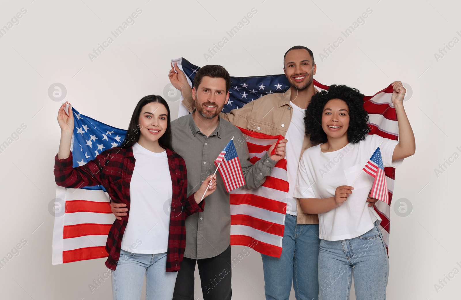 Photo of 4th of July - Independence Day of USA. Happy friends with American flags on white background