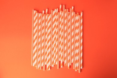 Photo of Many paper drinking straws on orange background, flat lay