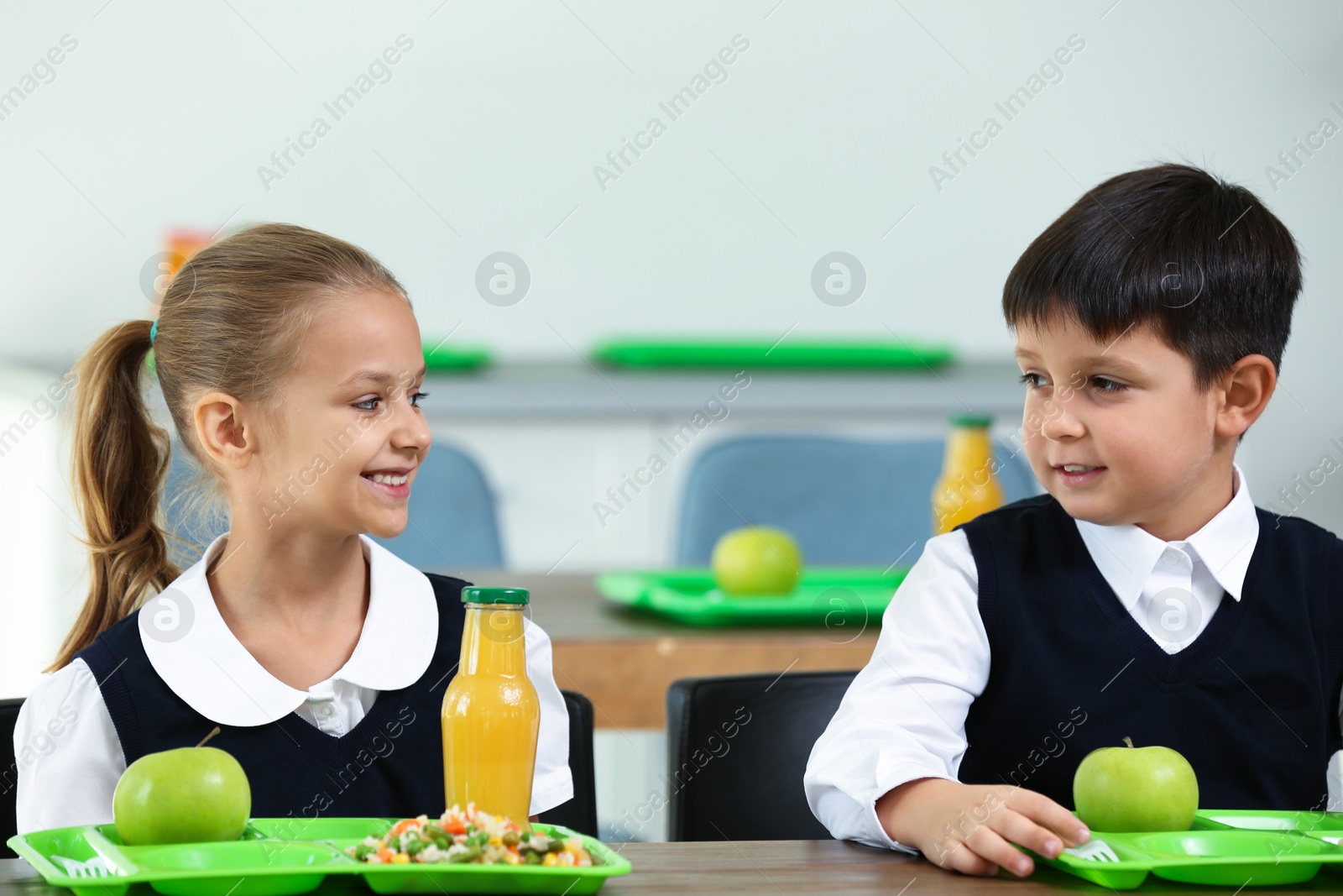 Photo of Happy children eating healthy food for lunch in school canteen