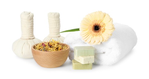 Spa composition. Towel, herbal massage bags, soap and dry flowers on white background