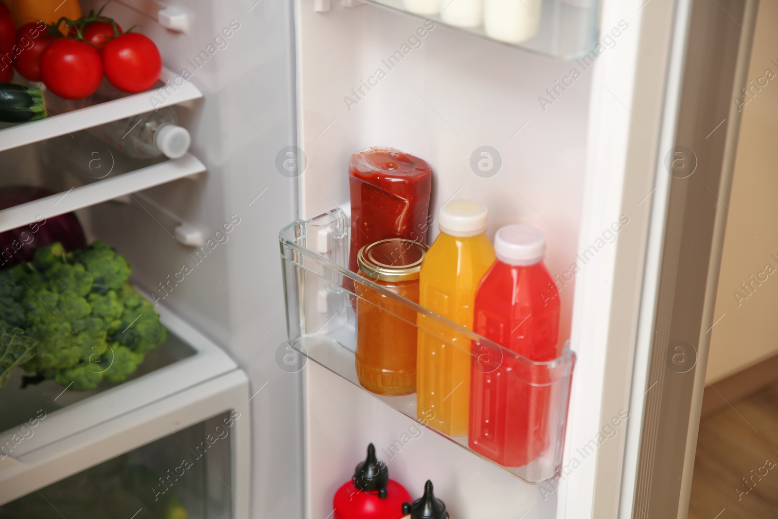 Photo of Open refrigerator with fresh food on shelves