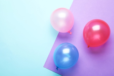 Photo of Flat lay composition with colorful balloons and space for text on color background