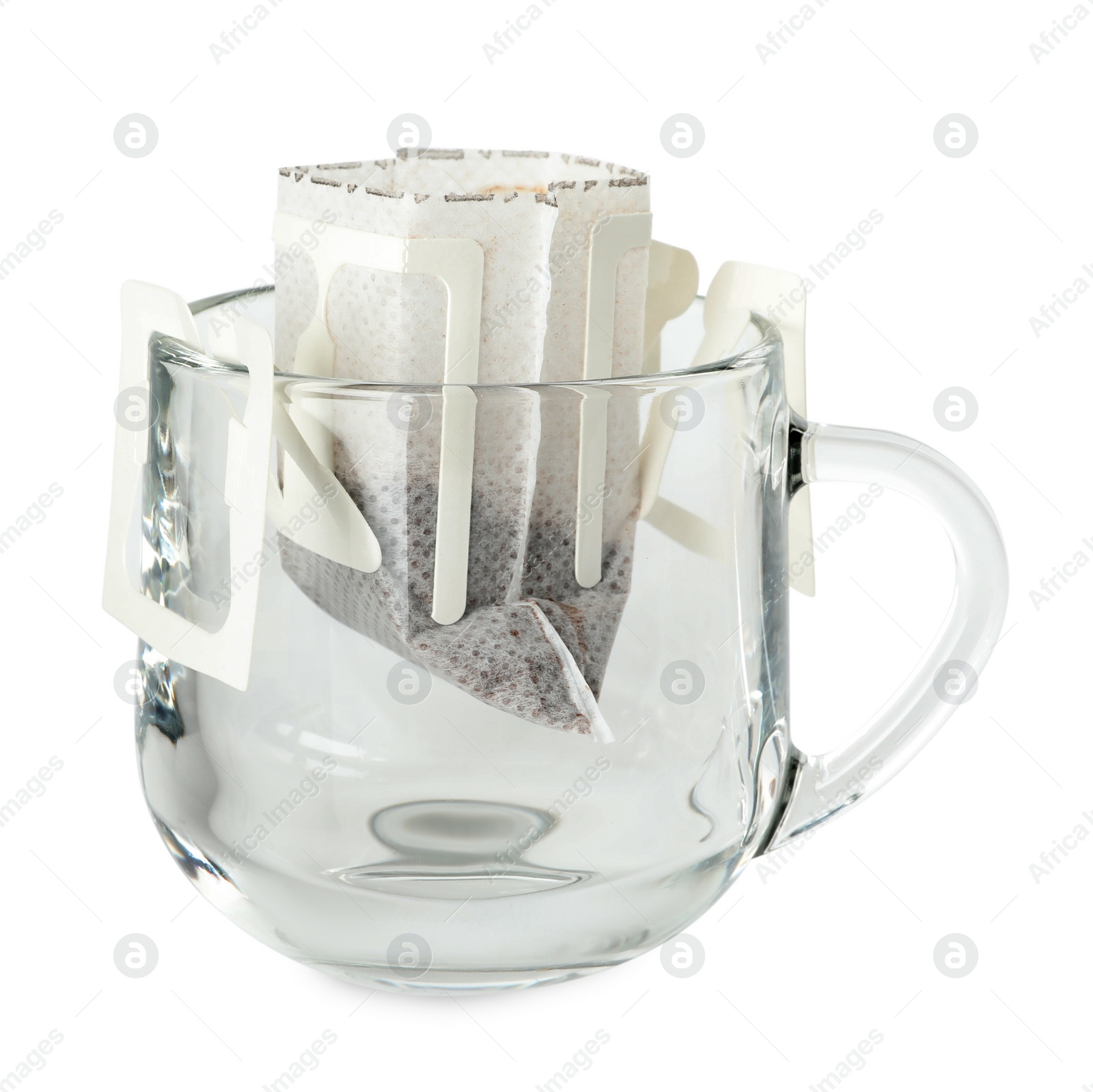 Photo of Glass cup with drip coffee bag isolated on white
