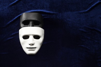 Theater arts. Two masks on blue fabric, top view. Space for text