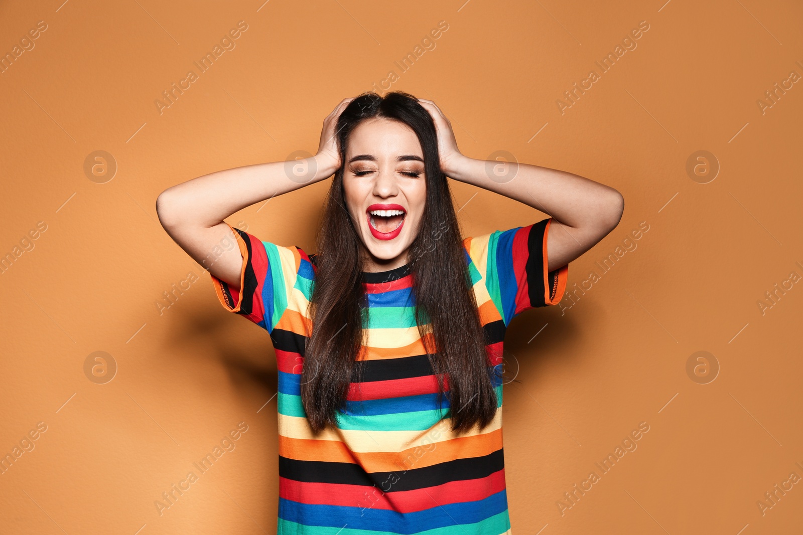 Photo of Portrait of emotional young woman on colorful background