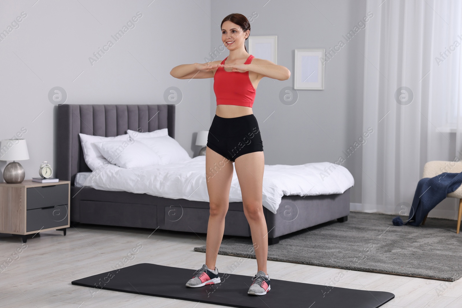 Photo of Happy woman doing morning exercise at home