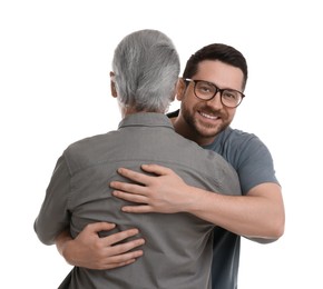 Happy son and his dad hugging on white background