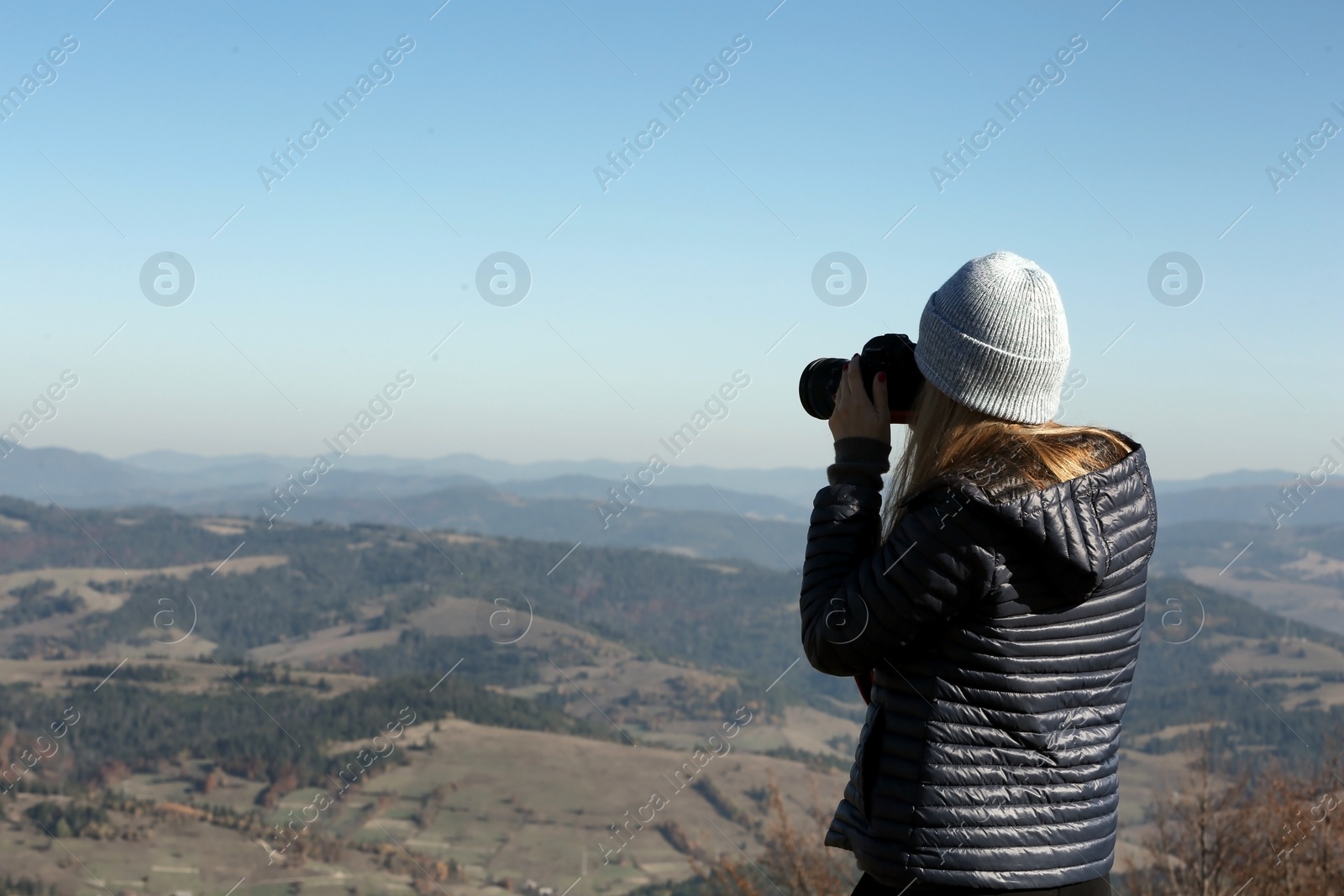 Photo of Professional nature photographer taking photo of mountain landscape
