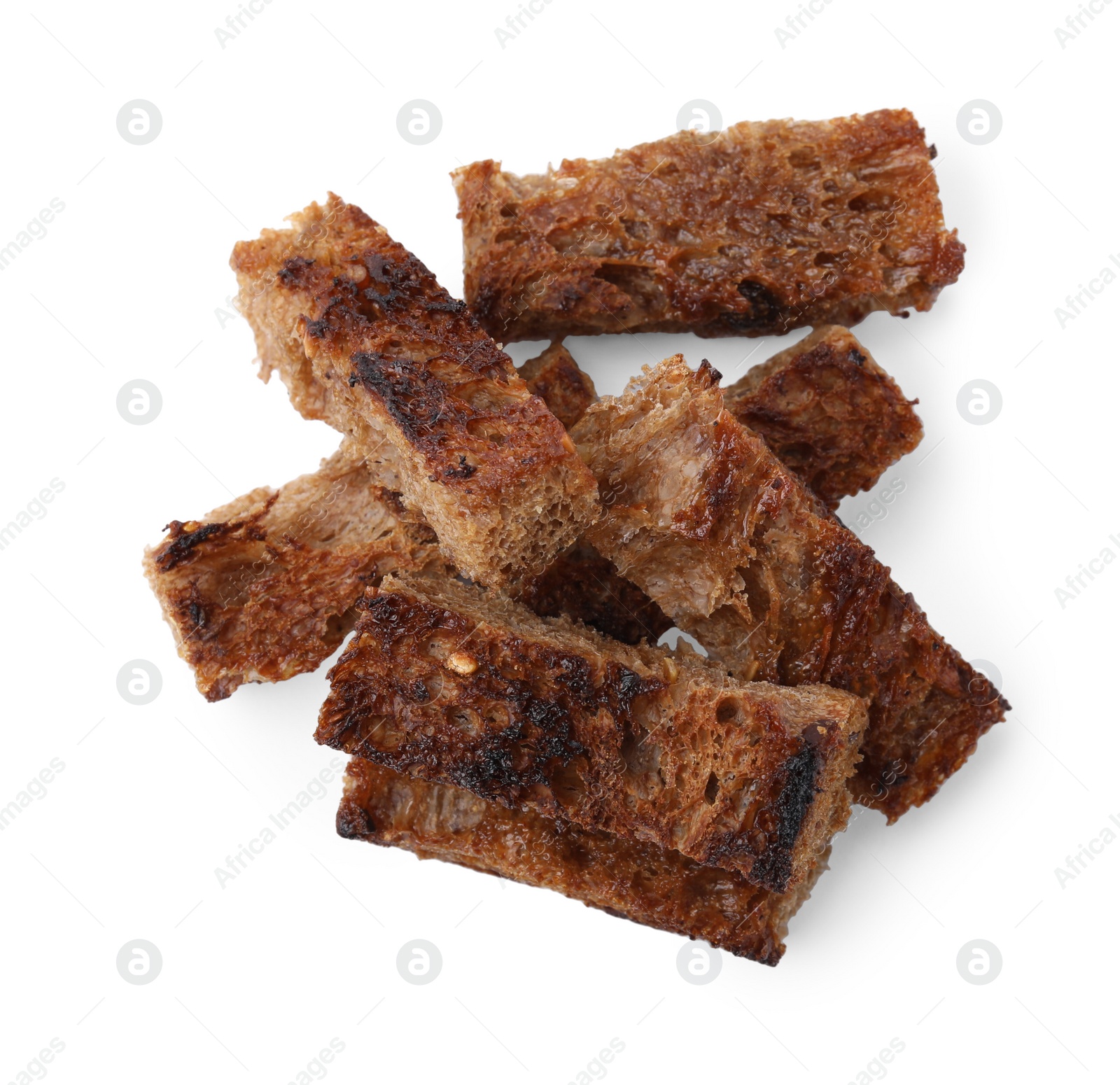 Photo of Heap of crispy rusks isolated on white, top view