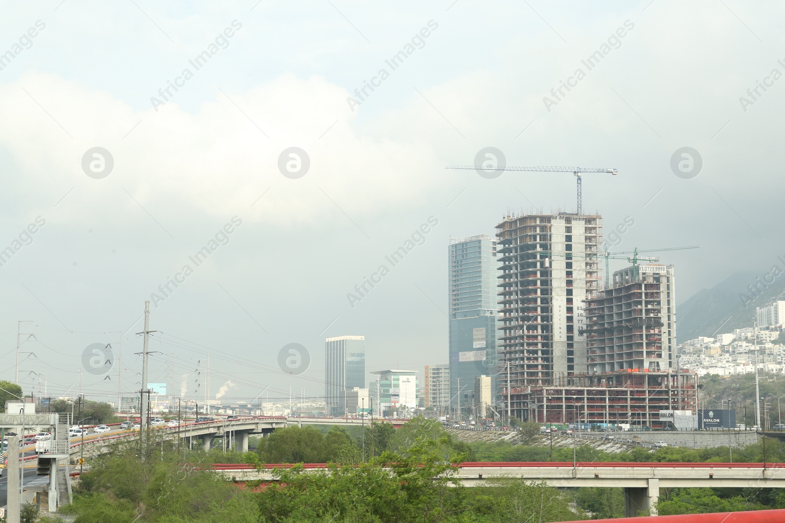 Photo of Beautiful view of unfinished buildings and road near mountains