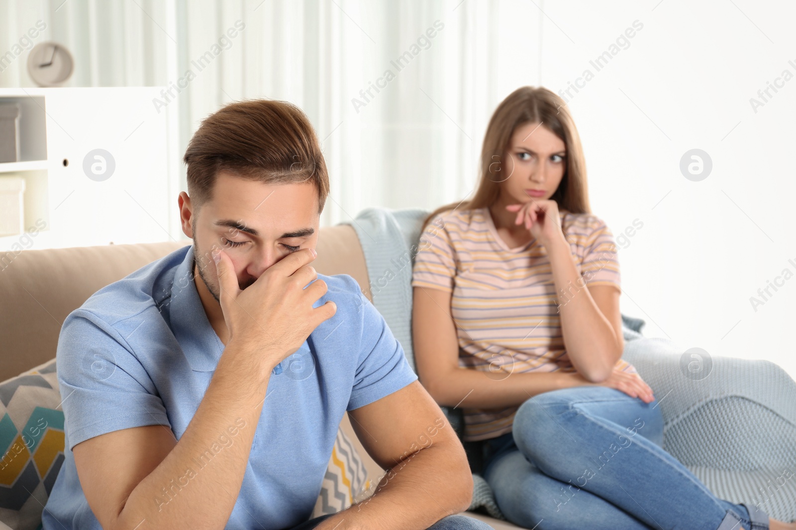 Photo of Young couple with relationship problems in living room