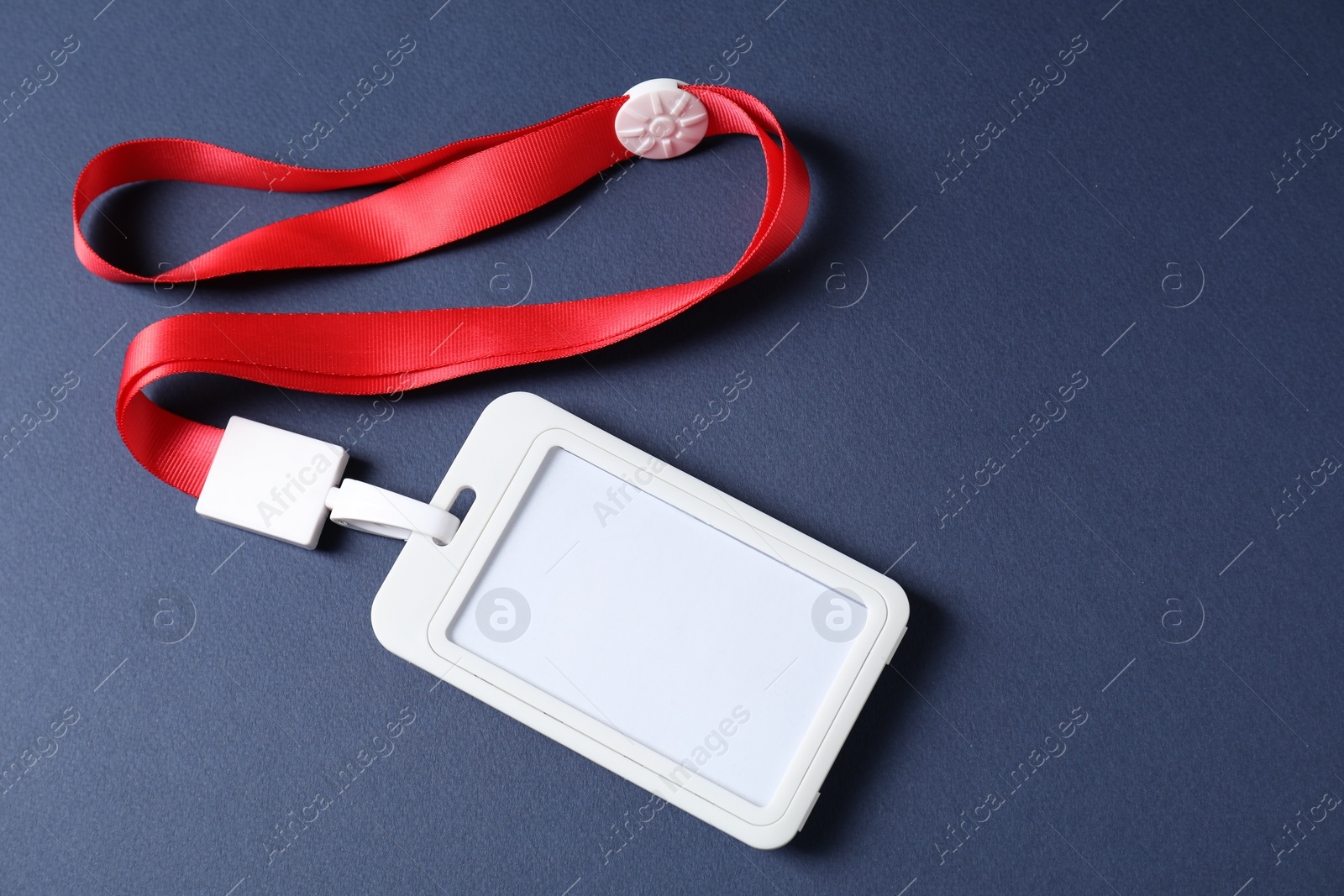 Photo of Blank badge with string on blue background, top view