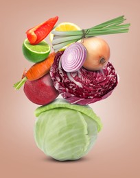 Image of Stack of different vegetables and fruits on pale pink background