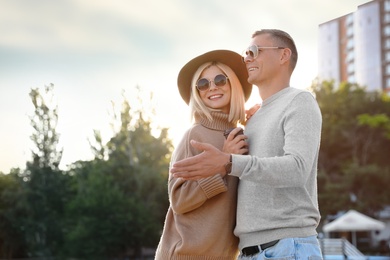 Photo of Couple in stylish sweaters on city street