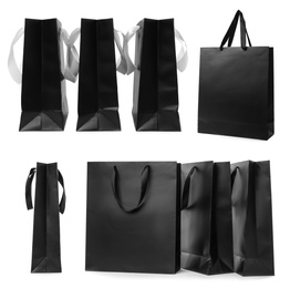 Image of Set with black paper shopping bags on white background