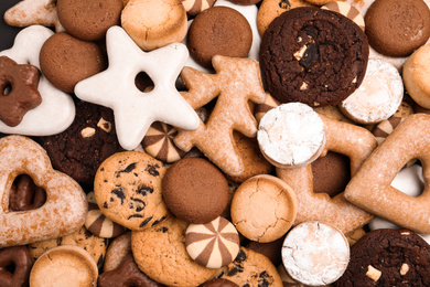 Photo of Different delicious cookies as background, top view