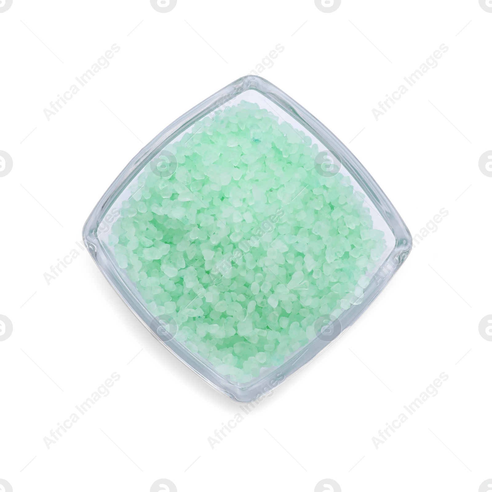 Photo of Glass bowl with turquoise sea salt isolated on white, top view