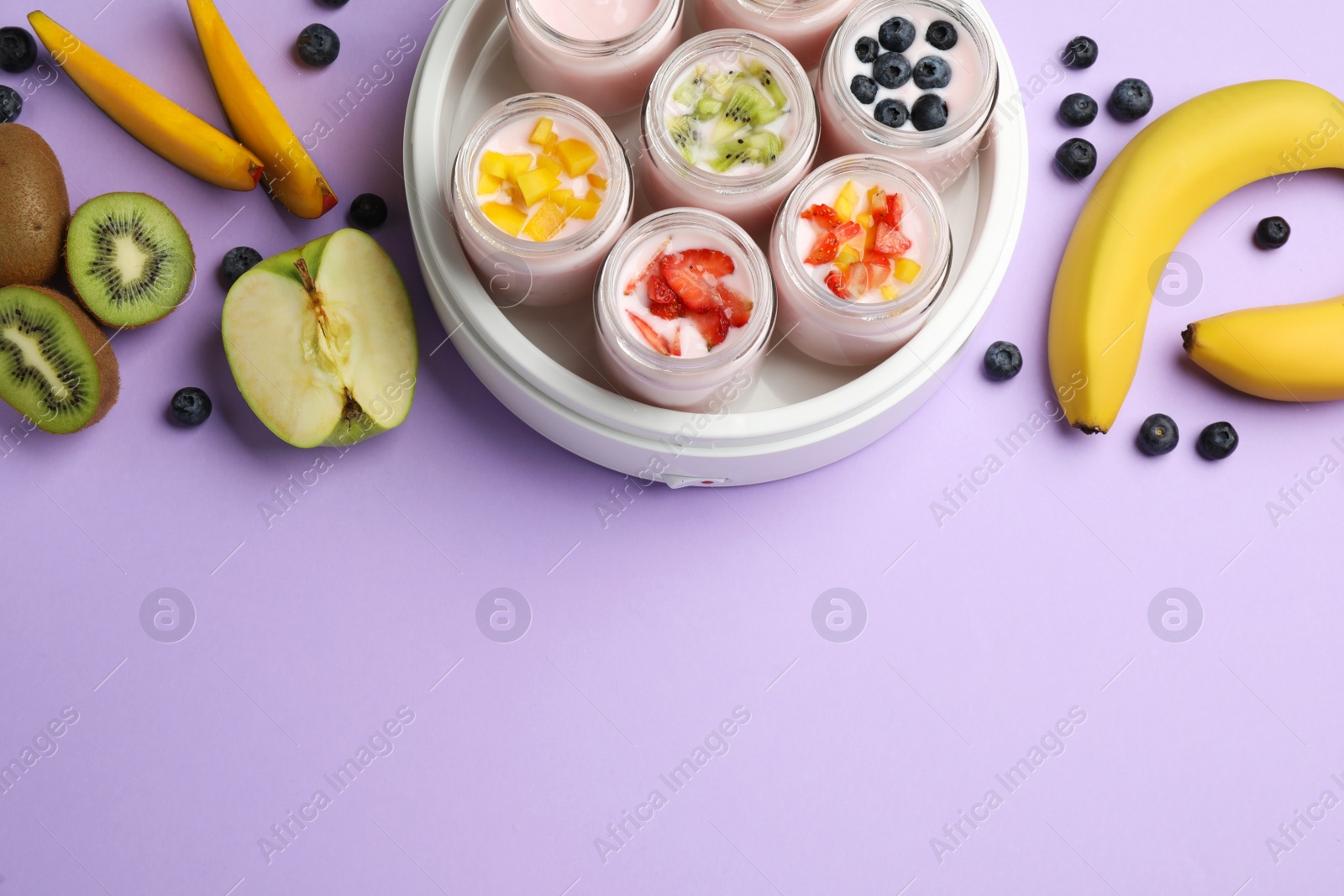 Photo of Yogurt maker with jars and different fruits on lilac background, flat lay. Space for text