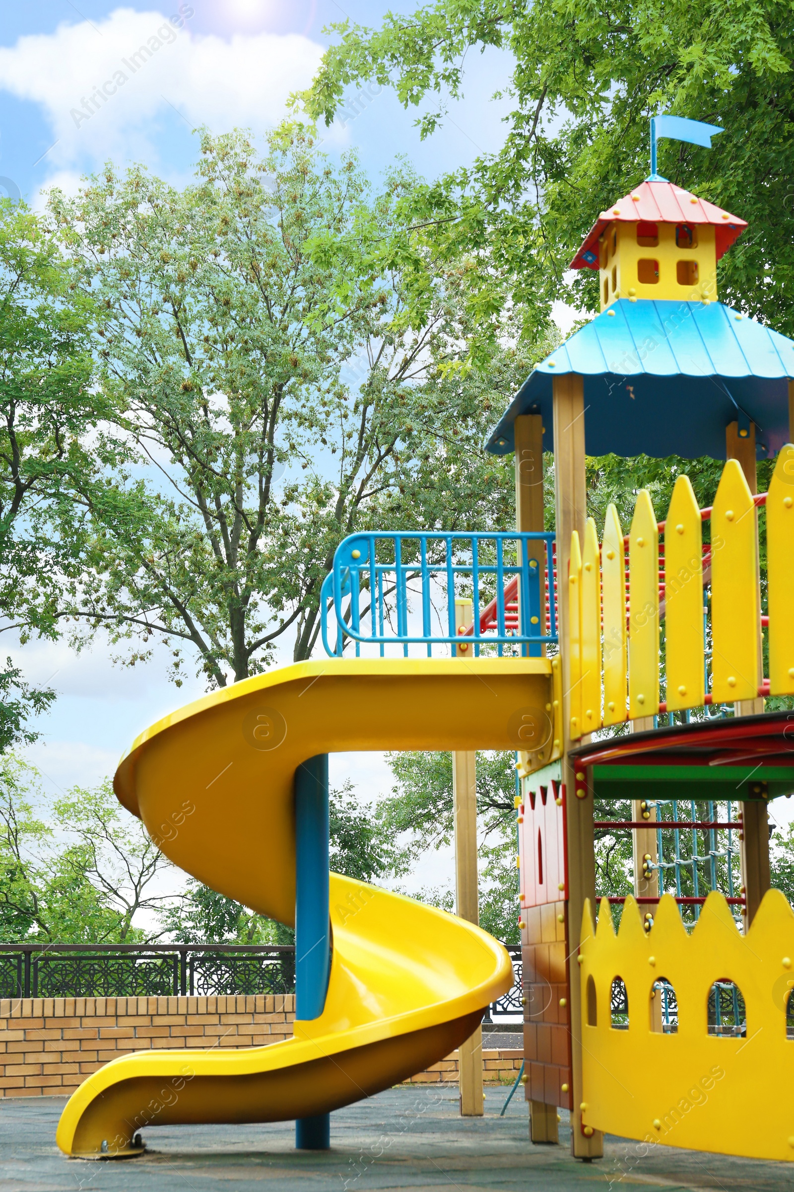 Photo of New colorful castle playhouse with slide on children's playground