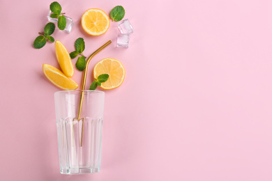 Photo of Creative lemonade layout with lemon slices, mint and ice on pink background, top view. Space for text