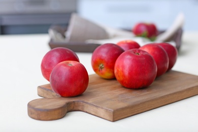 Photo of Ripe red apples on wooden board