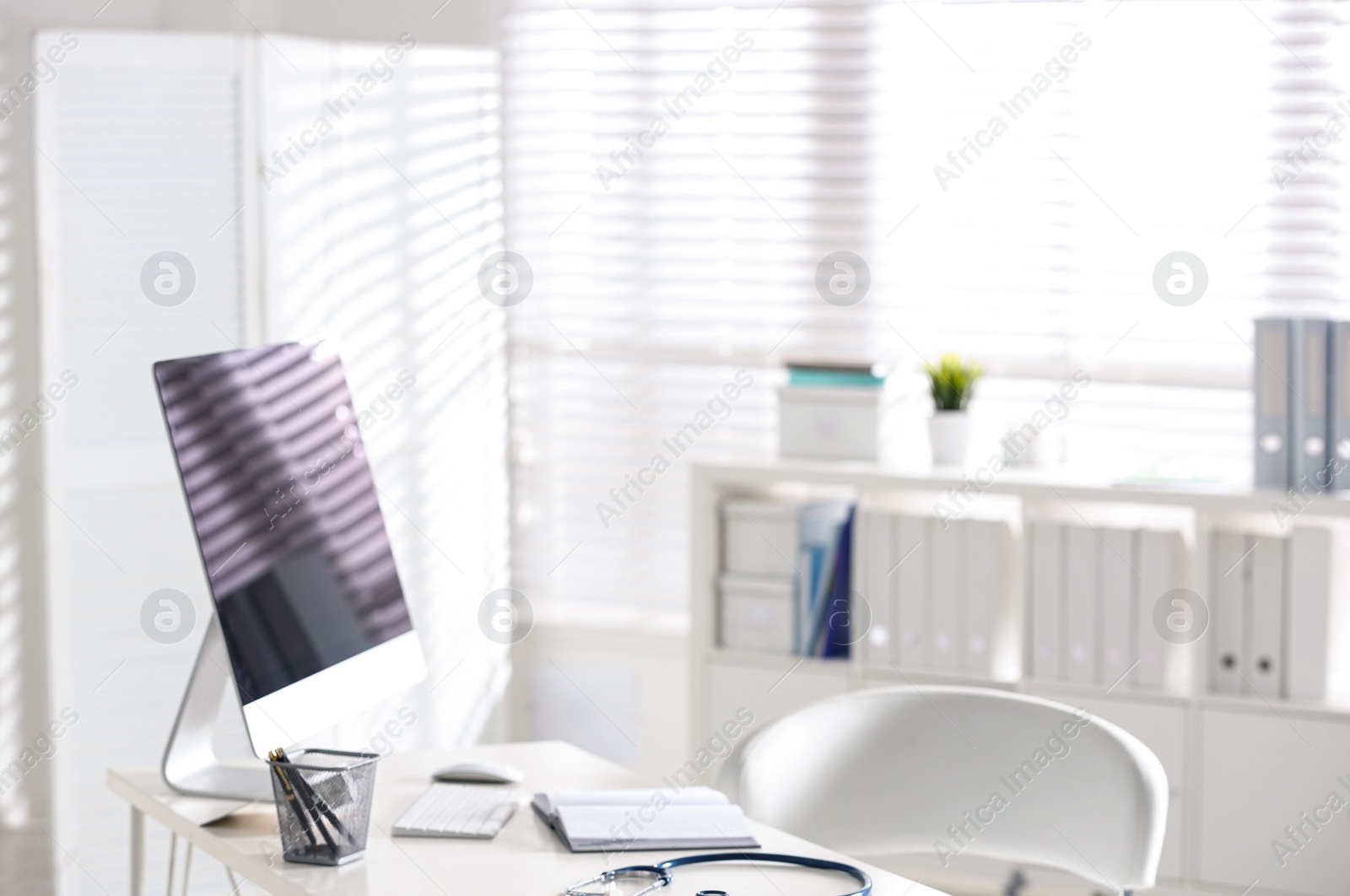 Photo of Doctor's workplace with modern computer in hospital